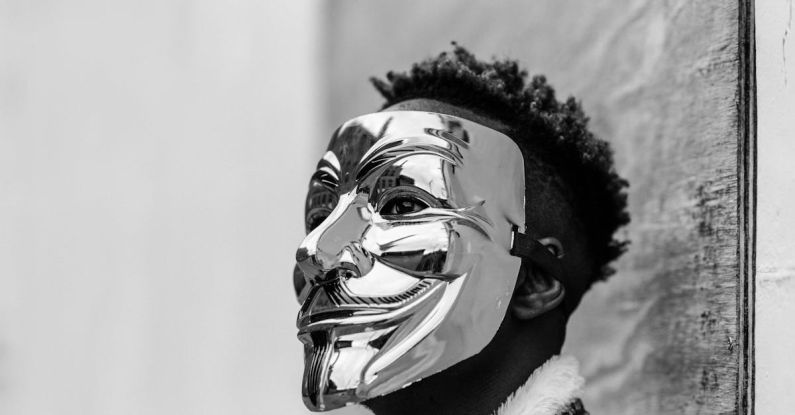 Government Policies - Black activist wearing Anonymous mask as sign of protest