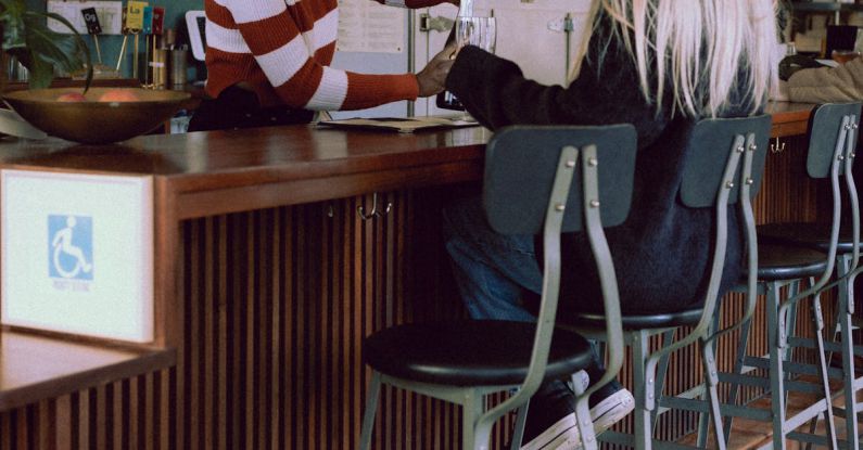 Customer Loyalty - A woman sitting at a bar with a man