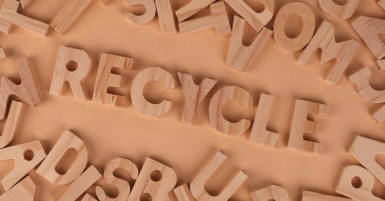 Sustainable Practices - The word recycle in wooden letters