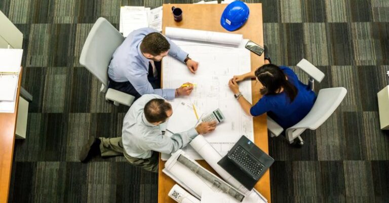 Property Management - Three People Sitting Beside Table