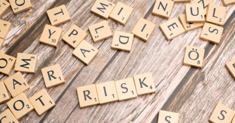 Risk Mitigation - Scrabble letters spelling risk on a wooden table