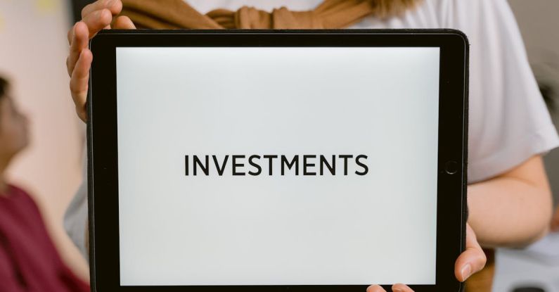 Diversified Investments - Close-Up Shot of a Person Holding a Tablet