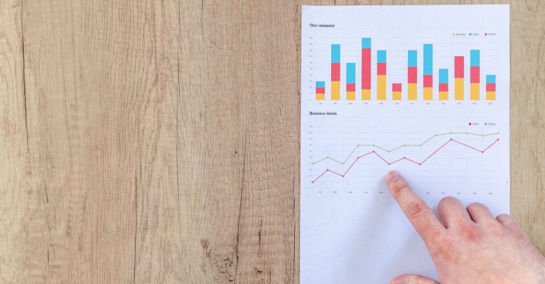 Financial Metrics - Person Pointing Paper Line Graph