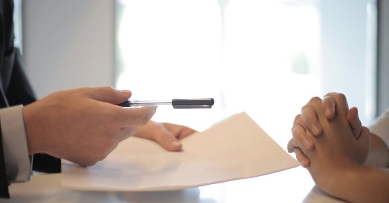 Credit Scores - Crop businessman giving contract to woman to sign