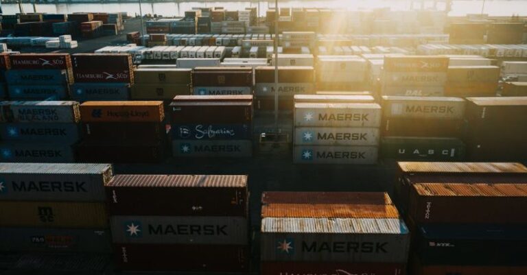 Global Manufacturing - Storage of many cargo containers in bright sunshine